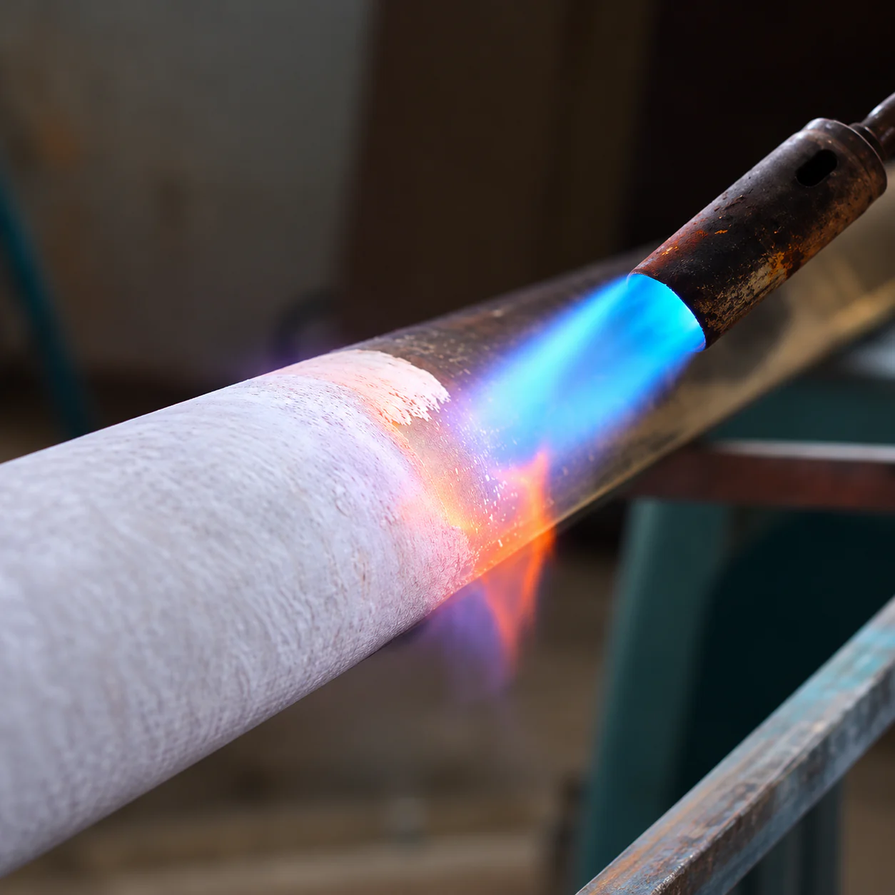 A flame heating metal during the finishing process