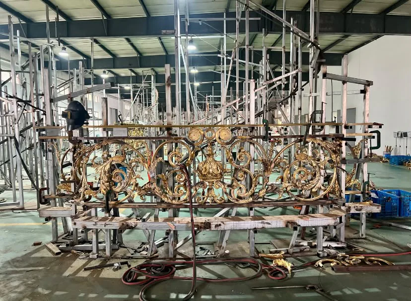 An ornate metal railing taking shape in the SHYDOOR workshop